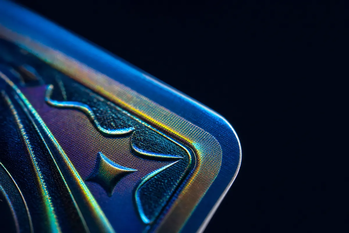 Extreme close-up of a foil card's corner, showing an embossed star symbol and rainbow sheen